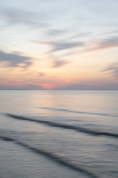 istock A dreamy, impressionistic paint like blurred sea sunset background with gently soft pastel colours. Vertical photo. 2236477456