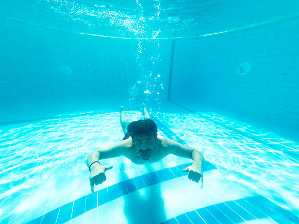 istock Young man enjoying the pool during the summer holidays 2236481470