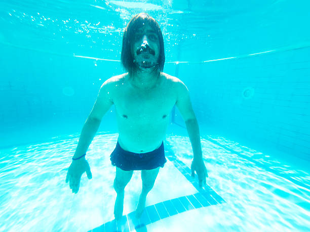 Young man enjoying the pool during the summer holidays