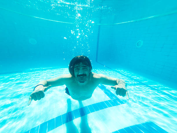 istock Young man enjoying the pool during the summer holidays 2236481480