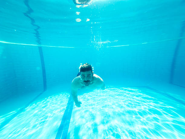 istock Young man enjoying the pool during the summer holidays 2236481481