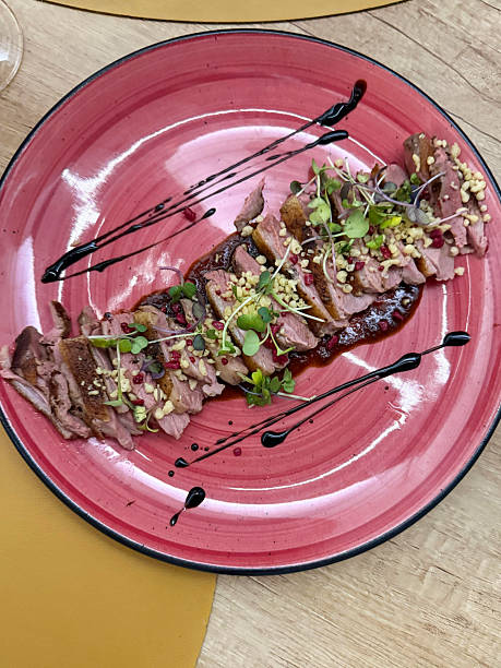istock Image of raw beef meat carpaccio sliced thin, balsamic vinegar dressing, salad garnish, fresh microgreens, gourmet appetizer plate 2236482821