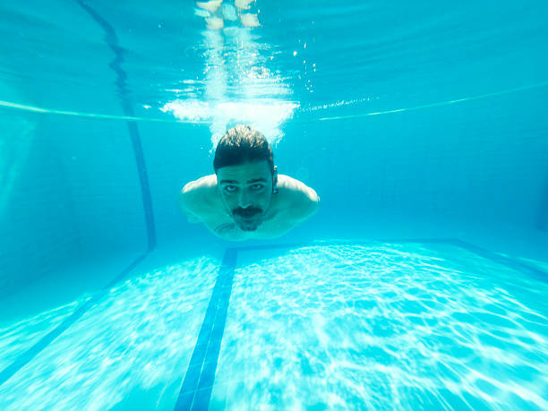 istock Young man enjoying the pool during the summer holidays 2236484159