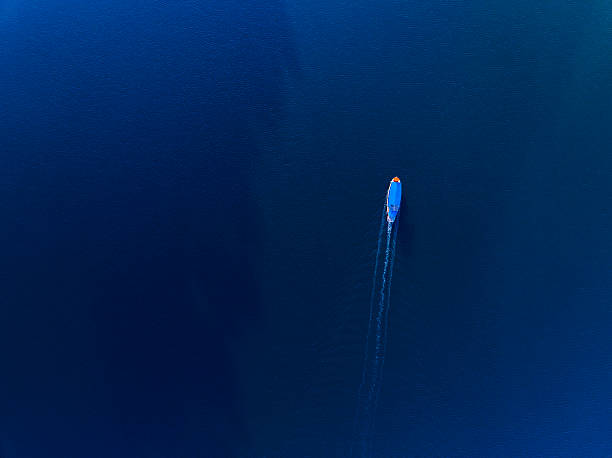 a boat sailing on the deep blue open sea