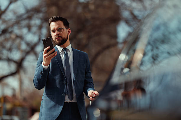 istock Smiling Businessman Using Smartphone Outdoors 2236489685