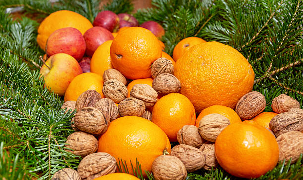 istock Abundance of fresh oranges, apples, walnuts, and Anthus Abies greenery 2236490003