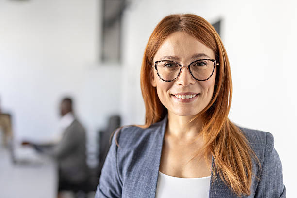 istock Smiling businesswoman in glasses in a modern office setting 2236490973