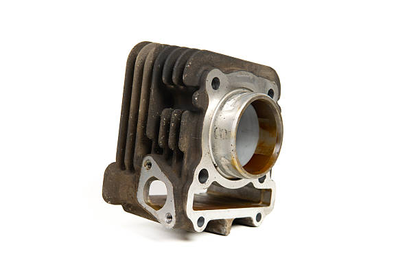 Close-up of a used motorcycle engine cylinder block part isolated on white background