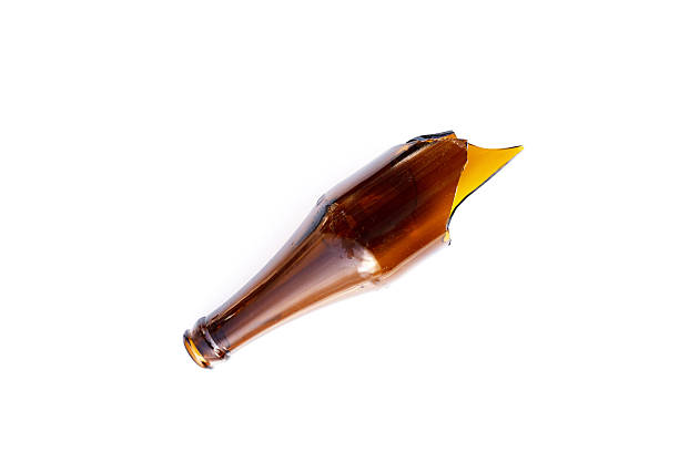 istock A broken brown glass bottle with sharp jagged edges at the top. 2236495068