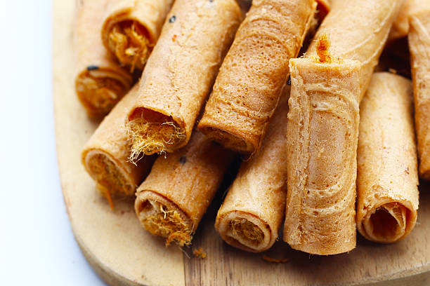 istock Rolled crispy wafers filled with shredded pork floss, Thai snack. 2236495474