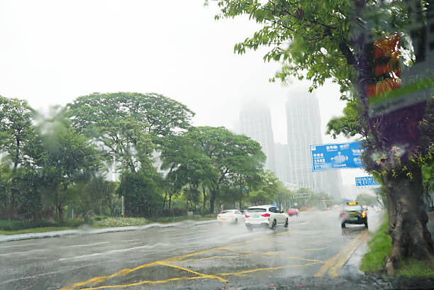 istock Busy traffic on road during storm rain through Car windshield 2236496100