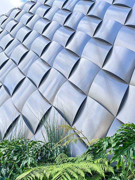 istock Abstract metallic architectural texture with natural green plants in foreground 2236497824