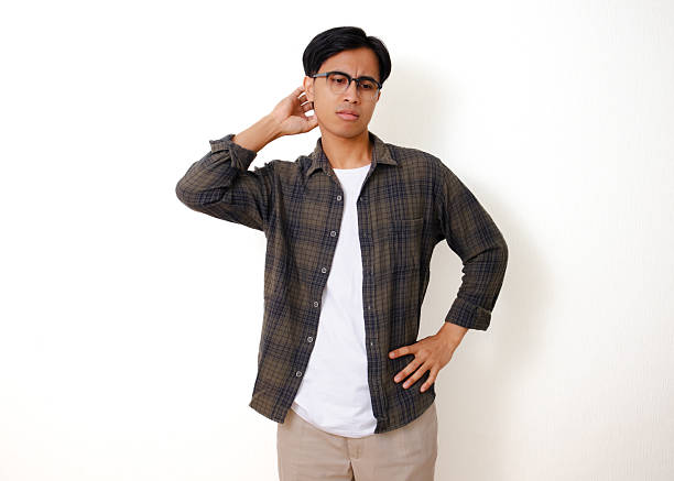 istock Stressed young Asian man scratching his head with a confused expression, isolated on white background 2236500081