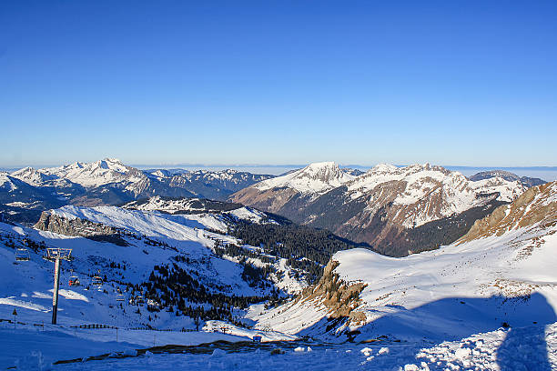 istock Alpine view with chairlift and snowy peaks 2236501092