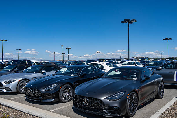 12/28/2024, Amsterdam, Netherlands: Modern mercedes-benz dealership showcasing various car models in a transparent, multi-level display tower