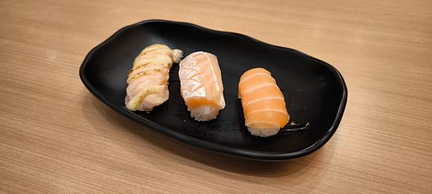 istock Sushi on a black plate on a wooden table 2236501448