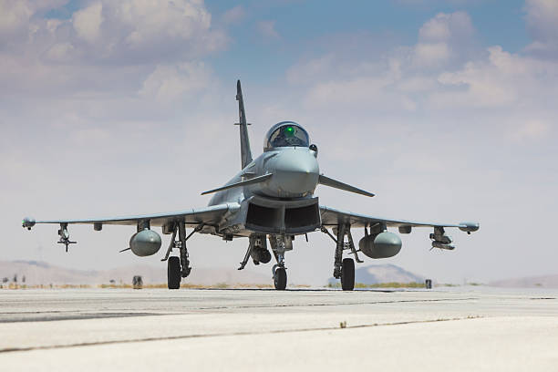 A pair of RAF Tornado GR1 fighter jets streaking through the sky, high above the sand dunes of a desert. Scale model photography