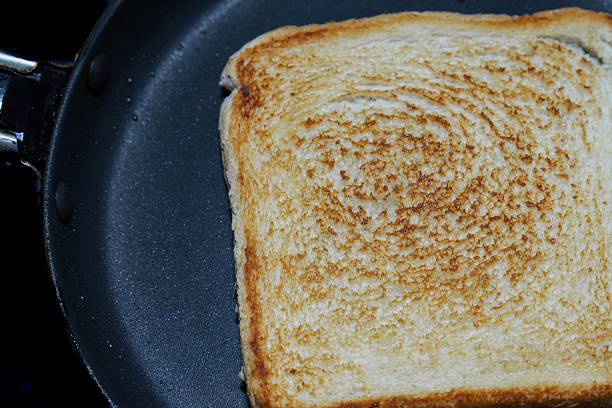 istock Toasting a single slice of white bread in a frying pan 2236507576