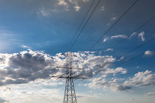 Photo of Power transmission tower with blue sky as background. Air electric lines.