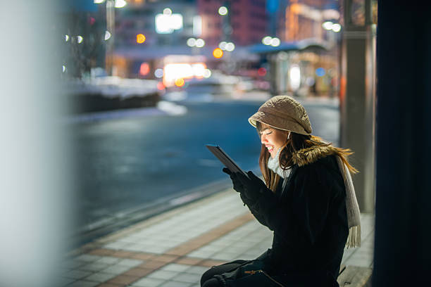 istock Young Asian woman using digital tablet in the city. 2236509876