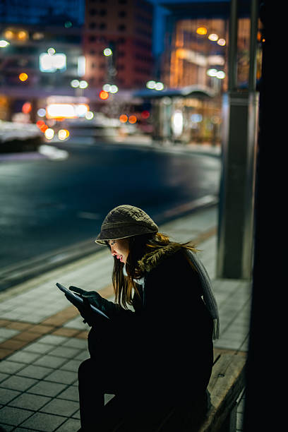 istock Young Asian woman using digital tablet in the city. 2236509877