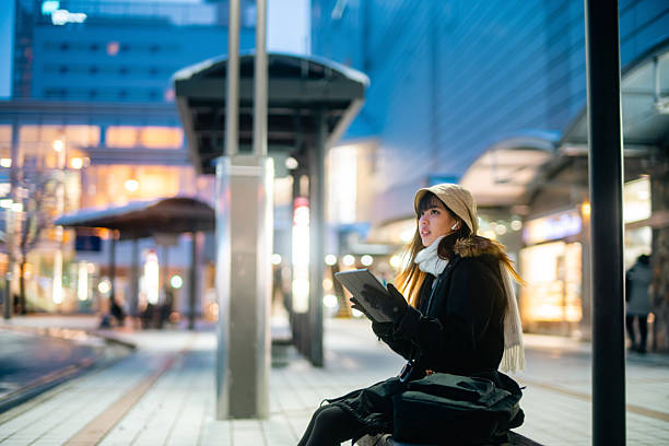 istock Young Asian woman using digital tablet in the city. 2236509881