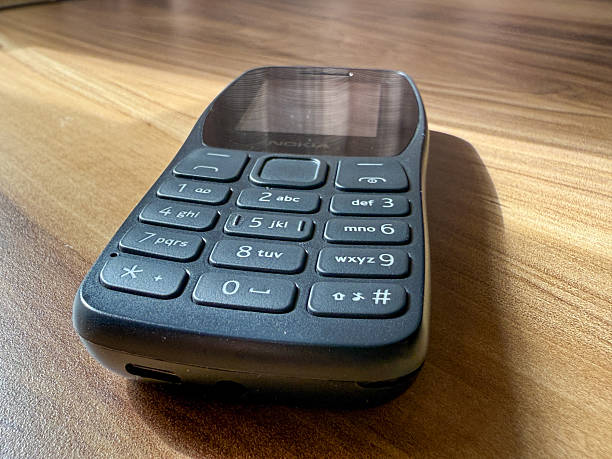A Nokia phone is sitting on a wooden table