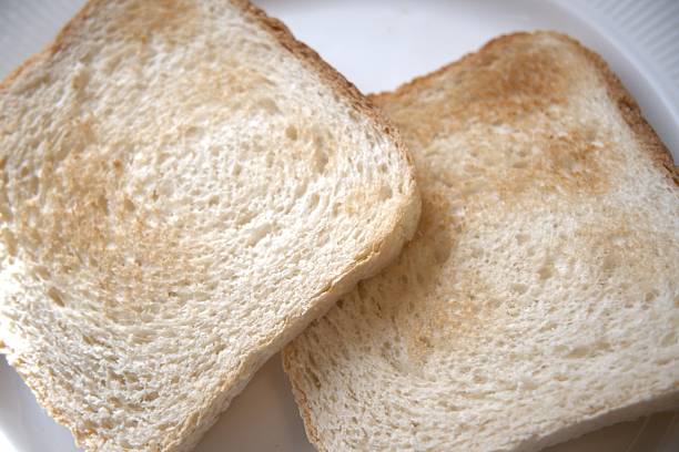 Some toasts or toasted breads, on white plate, isolated on white background
