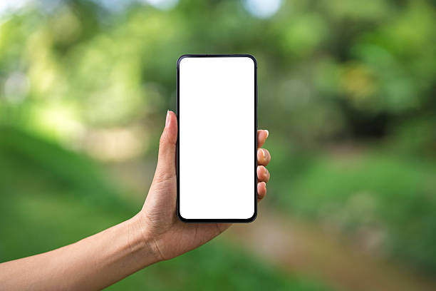istock Hand holding smartphone with blank screen outdoors 2236517508