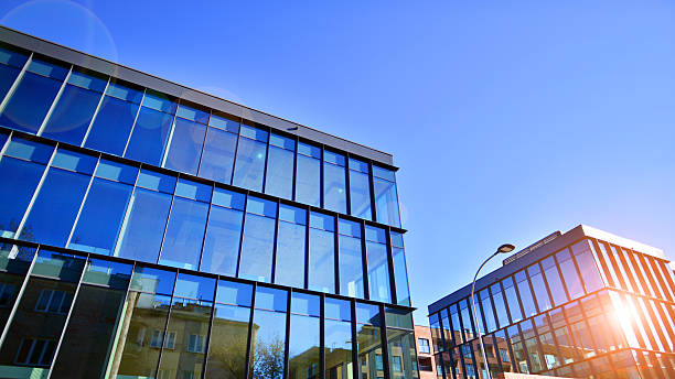 istock Exterior of modern building with many windows against blue sky, low angle view. 2236520416