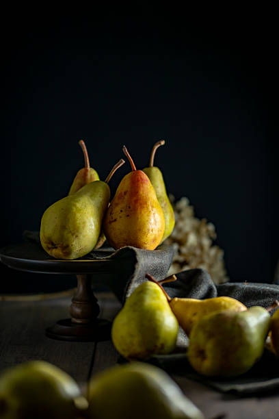 istock Still Life with Pears on Dark Background 2236521210