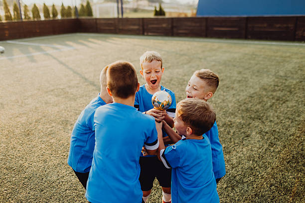 istock Junior football team celebrating victory 2236521248