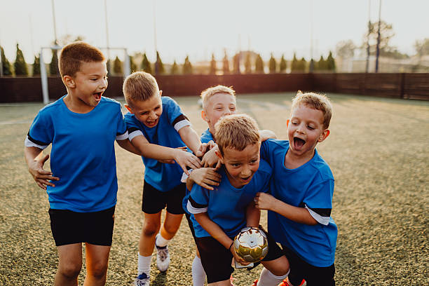 istock Junior football team celebrating victory 2236521318