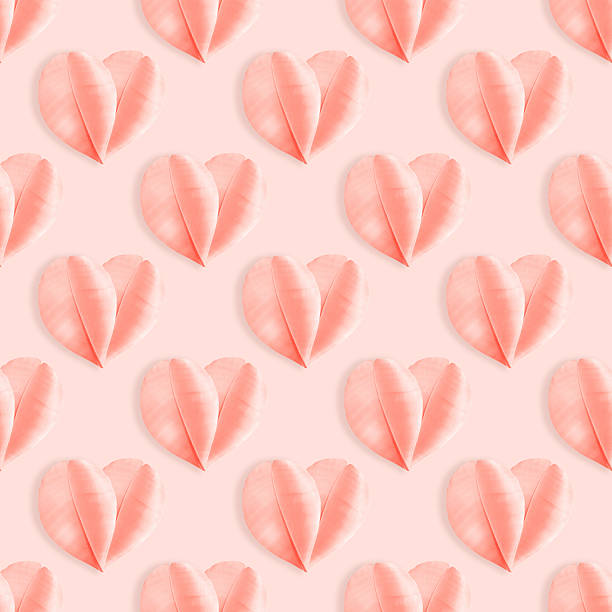istock Minimalist pastel seamless pattern from delicate pink feathers arranged as heart shapes on soft rose background. Concept of love, tenderness, and romance, holiday greetings for Valentine Day, wedding 2236523402