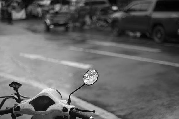 Motorcycle side mirror on the raining street