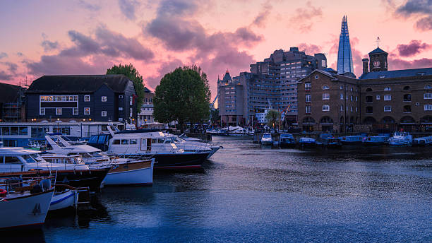 Tranquil twilight seascape at St Katharine Docks Marina, built in the 1820s on the River Thames, now a vibrant waterside hub with boat berths, shops, restaurants, and residences in central London.