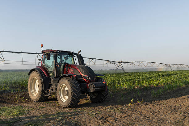 istock Tractor and agricultural watering pivot irrigation system 2236528259