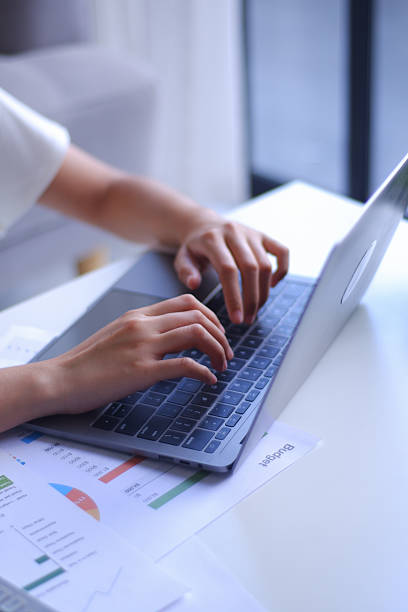 istock Closeup young women remote work from home analyzing data, using calculator and laptop. 2236529610