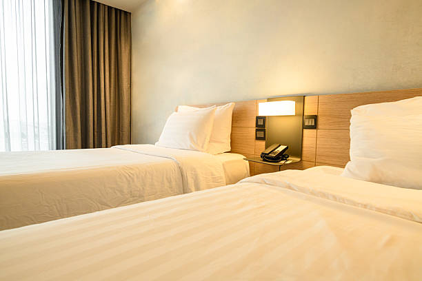 istock A double bed covered with white sheds in a beautiful bedroom. 2236531334