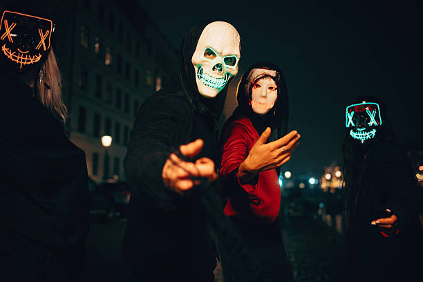 istock People in illuminated masks celebrating the night in a city setting 2236531859