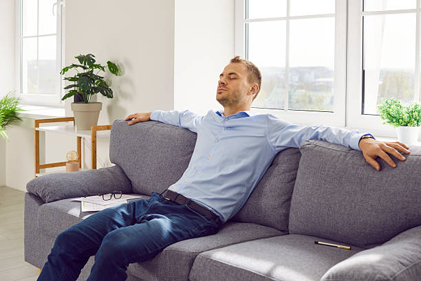 istock Young business man taking pause during work or having weekend, sitting on sofa and relaxing 2236532700
