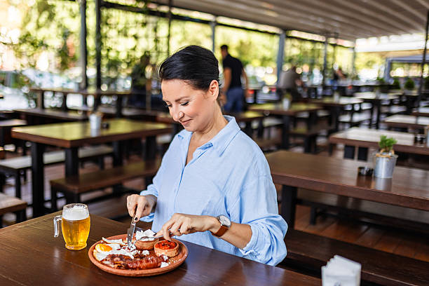 istock Cheerful female having lunch and drink in pub 2236535251