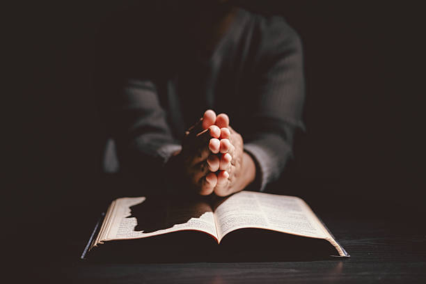 istock Hands folded in prayer on the Holy Bible, symbolizing faith, devotion, Christianity, hope, and spiritual strength. Concept of worship, meditation and trusting God Word. 2236537809