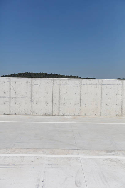 istock Minimalist Concrete Wall with Clear Blue Sky 2236538465