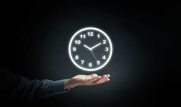 istock Conceptual image of a glowing clock floating above a businessman hand, symbolizing time management, scheduling, deadline control, and productivity in modern business and lifestyle. 2236546941