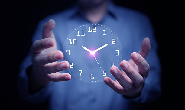 istock Businessman holding digital glowing clock in hands, symbolizing time management, control, efficiency, productivity, corporate planning, and leadership in modern business strategy. 2236546949