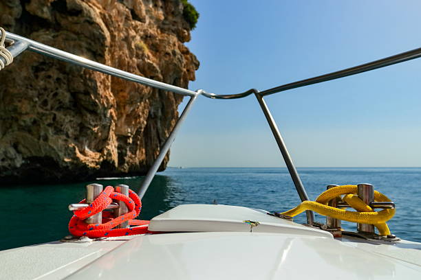 Cheerful woman sitting at the front of the boat.