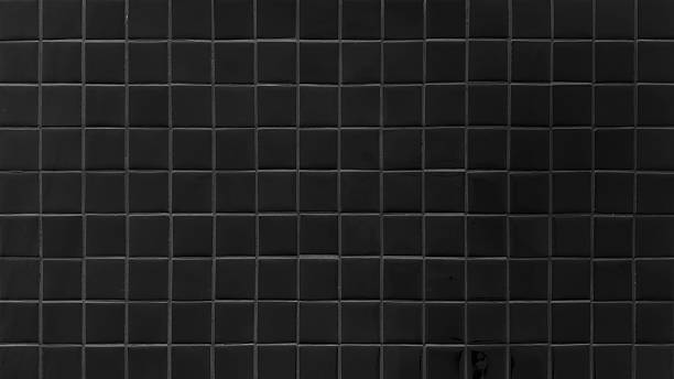 istock dark black square tile with grey grout wall texture background. Clean ceramic bathroom or kitchen surface. 2236547686