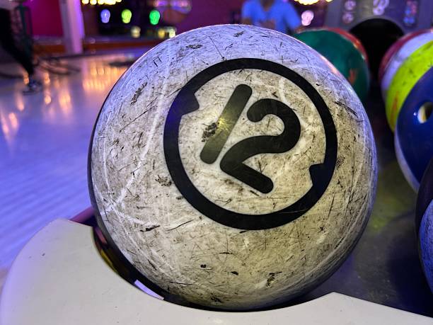 Closer scene on human hand wiping bowling ball.