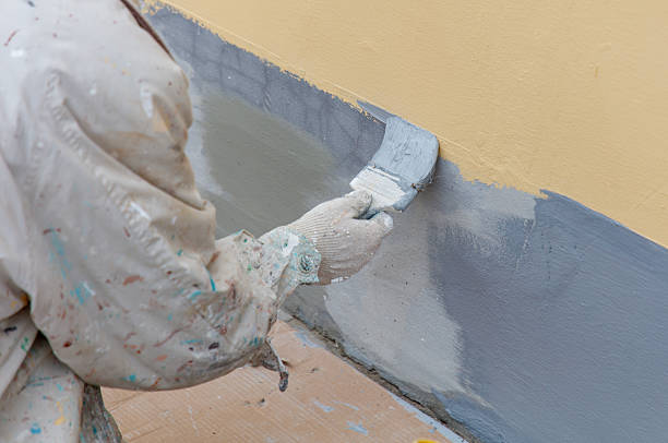 istock A man is painting a wall with a brush 2236548248